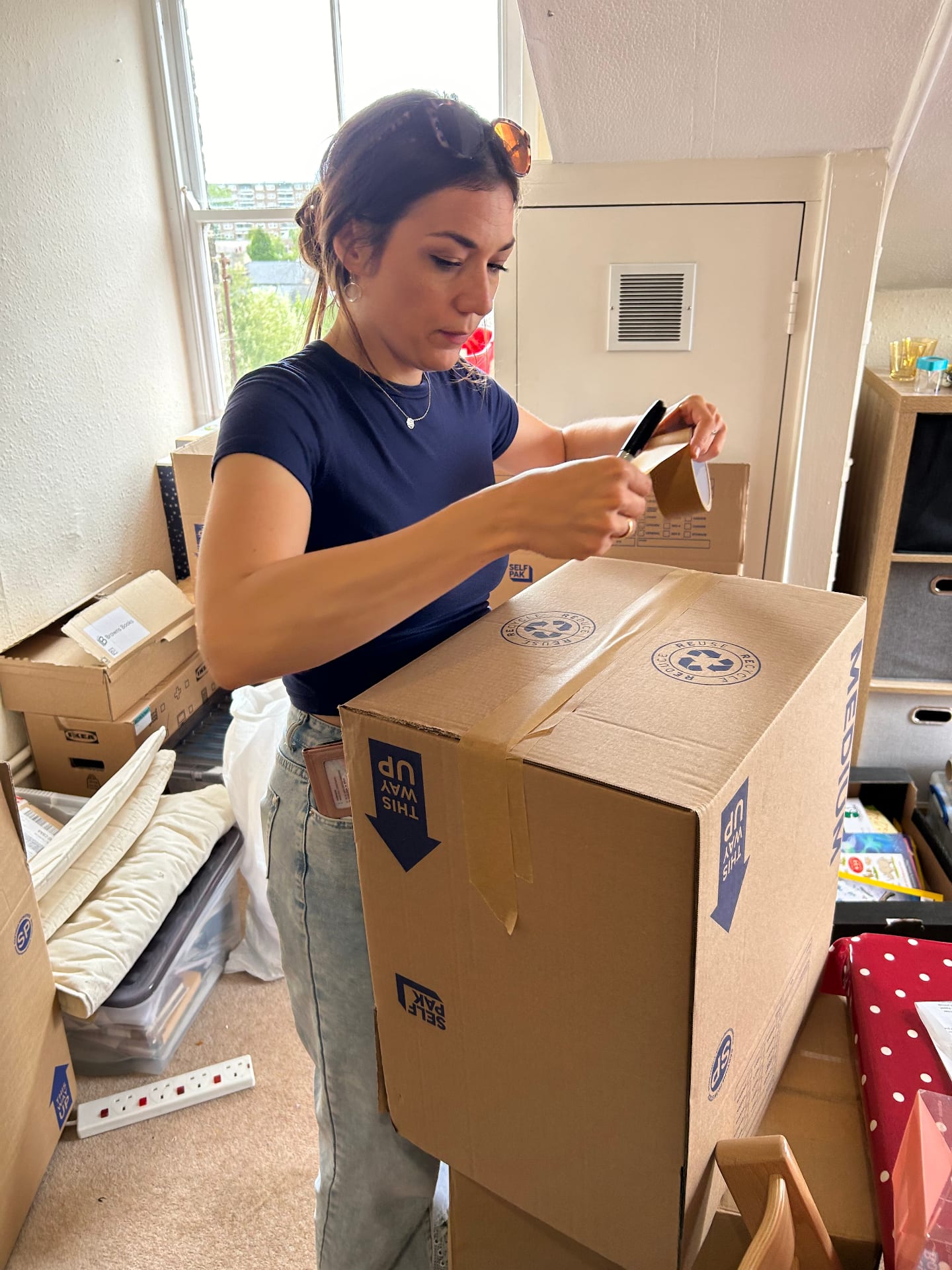 Professional packer wrapping a framed picture with bubble wrap