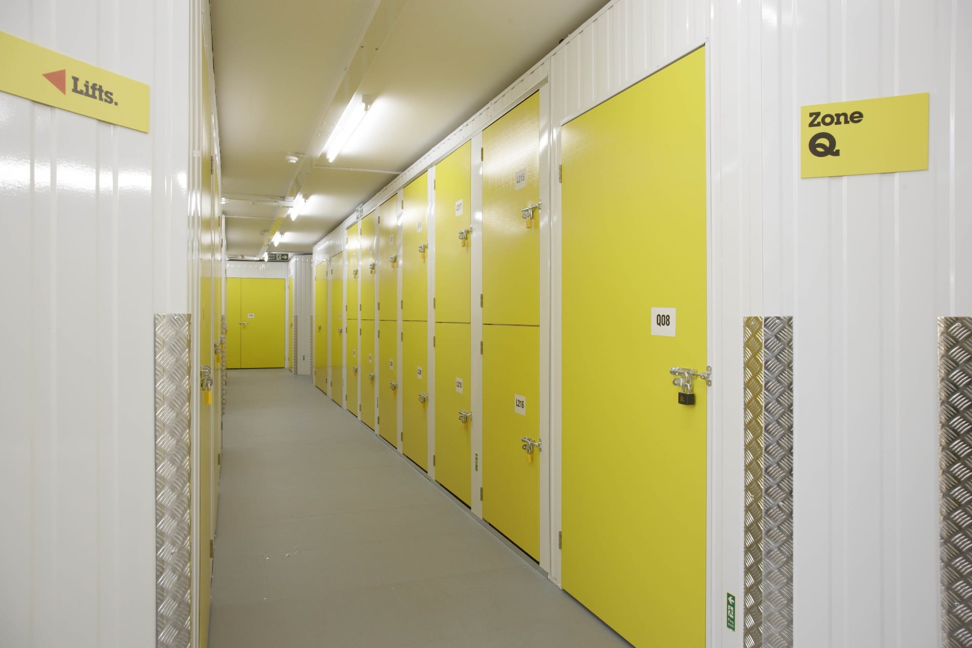 Inside view of a yellow Big Yellow self-storage unit packed with neatly organised boxes